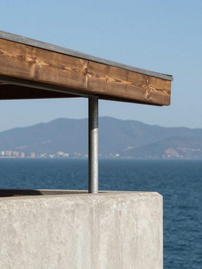 A timber roof edge resting on a slim steel column with a concrete base.